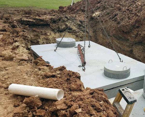 depositphotos_186524232-stock-photo-crane-putting-septic-holding-tanks.jpg